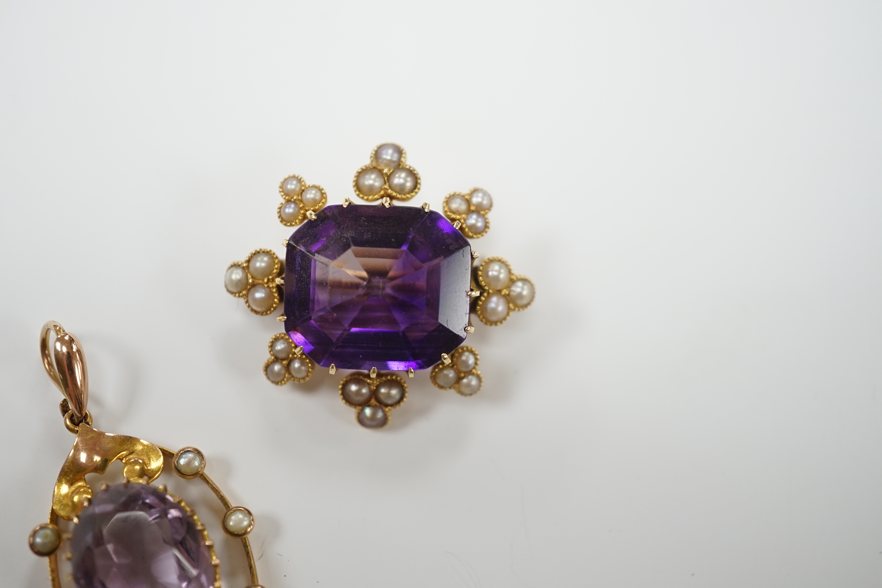 An early 20th century yellow metal, amethyst and seed pearl set brooch, 26mm and a similar pendant, gross weight 9.9 grams.